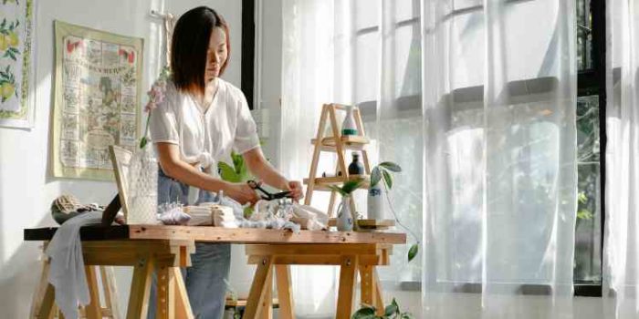 woman using scissors for art project