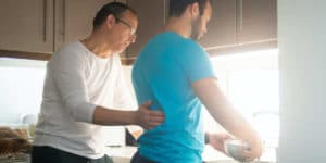 father and adult son doing dishes