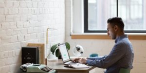 Sad man sitting in front of computer at work