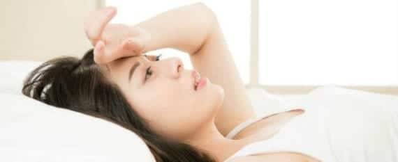 overwhelmed woman lying on bed