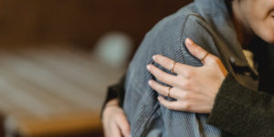 grieving woman being consoled