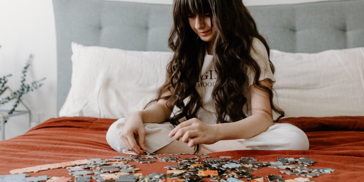 young girl working on a puzzle