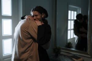 A girl crying while hugging a man