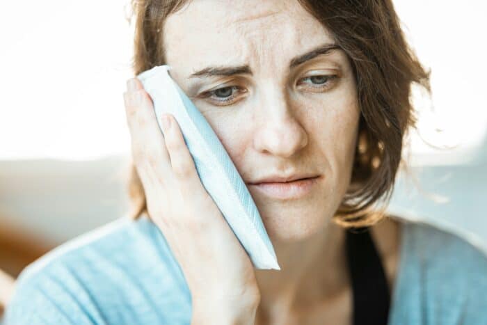 woman experiencing tooth pain