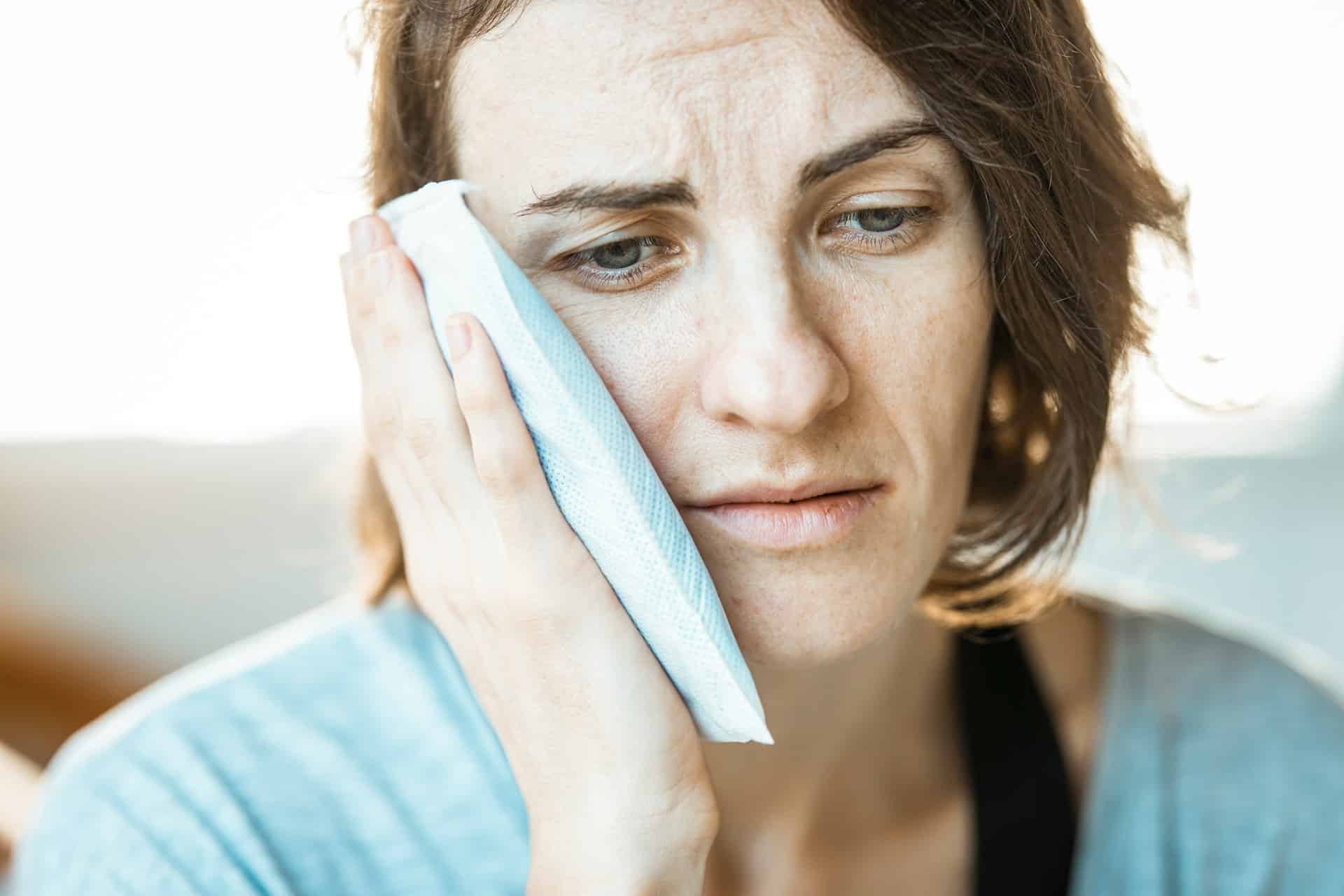 woman experiencing tooth pain