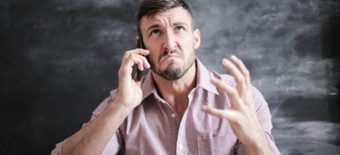 an angry man talking on the phone