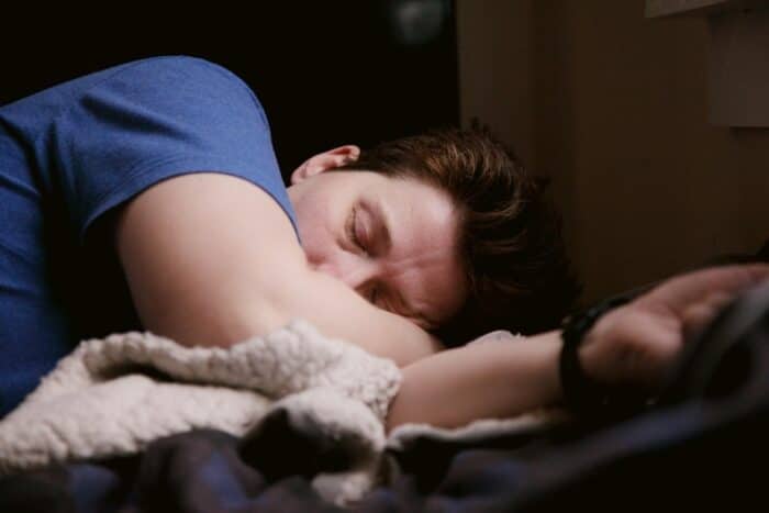 A person lying in their bed