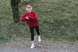 Woman outdoors exercising with resistance band and headphones