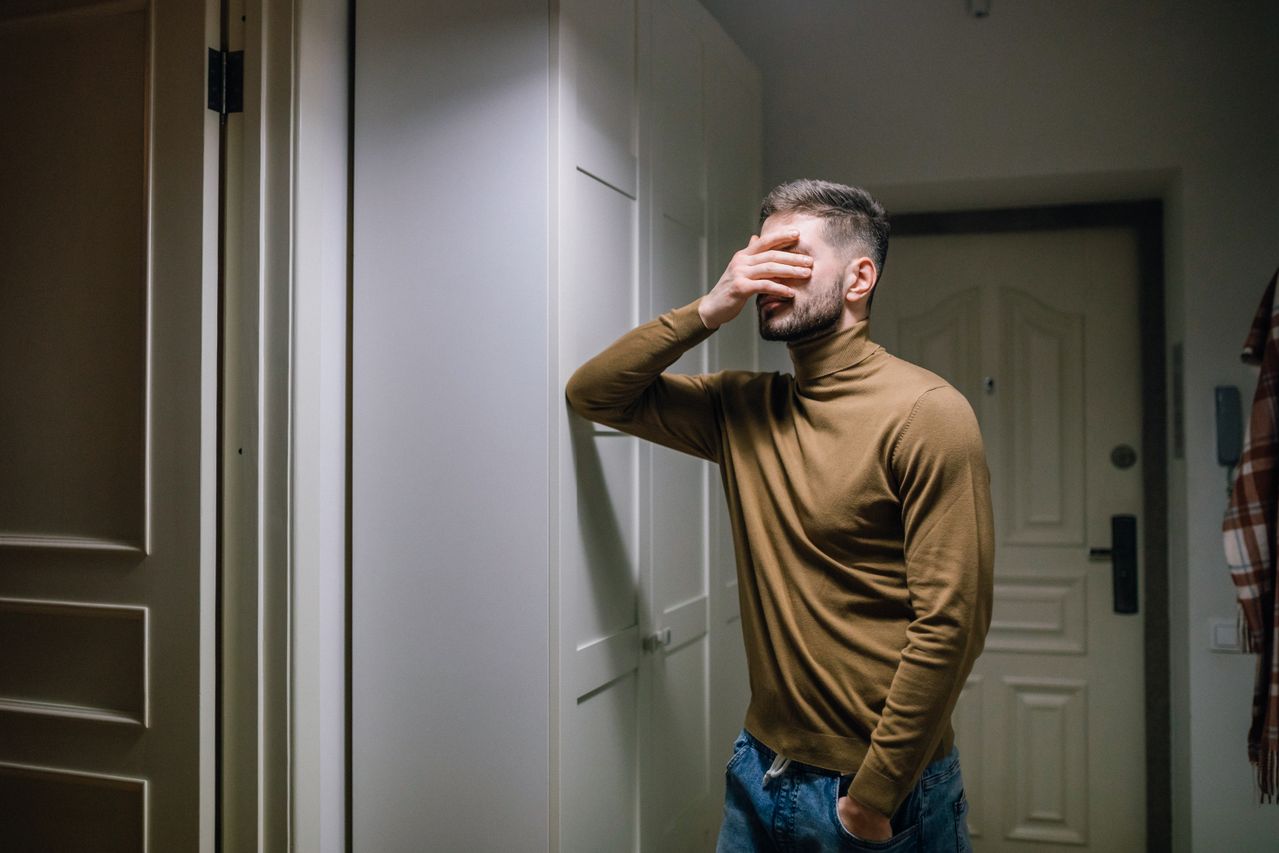 distressed man with a hand on his face