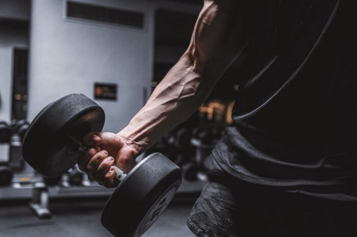 Close-up of a muscular arm holding a dumbbell