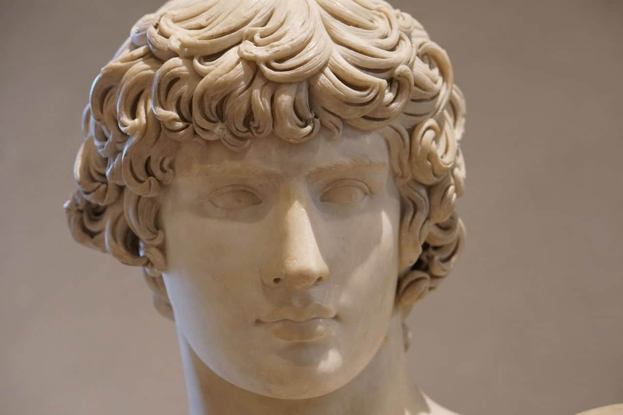 Detailed close-up of a classical Greek-style marble statue