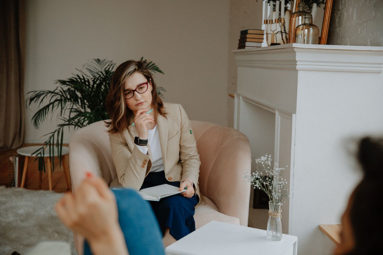 thoughtful female therapist engages in a counseling session indoors