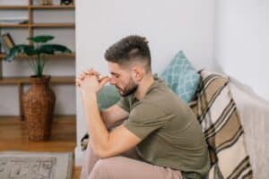 Young man sitting a counselor's couch