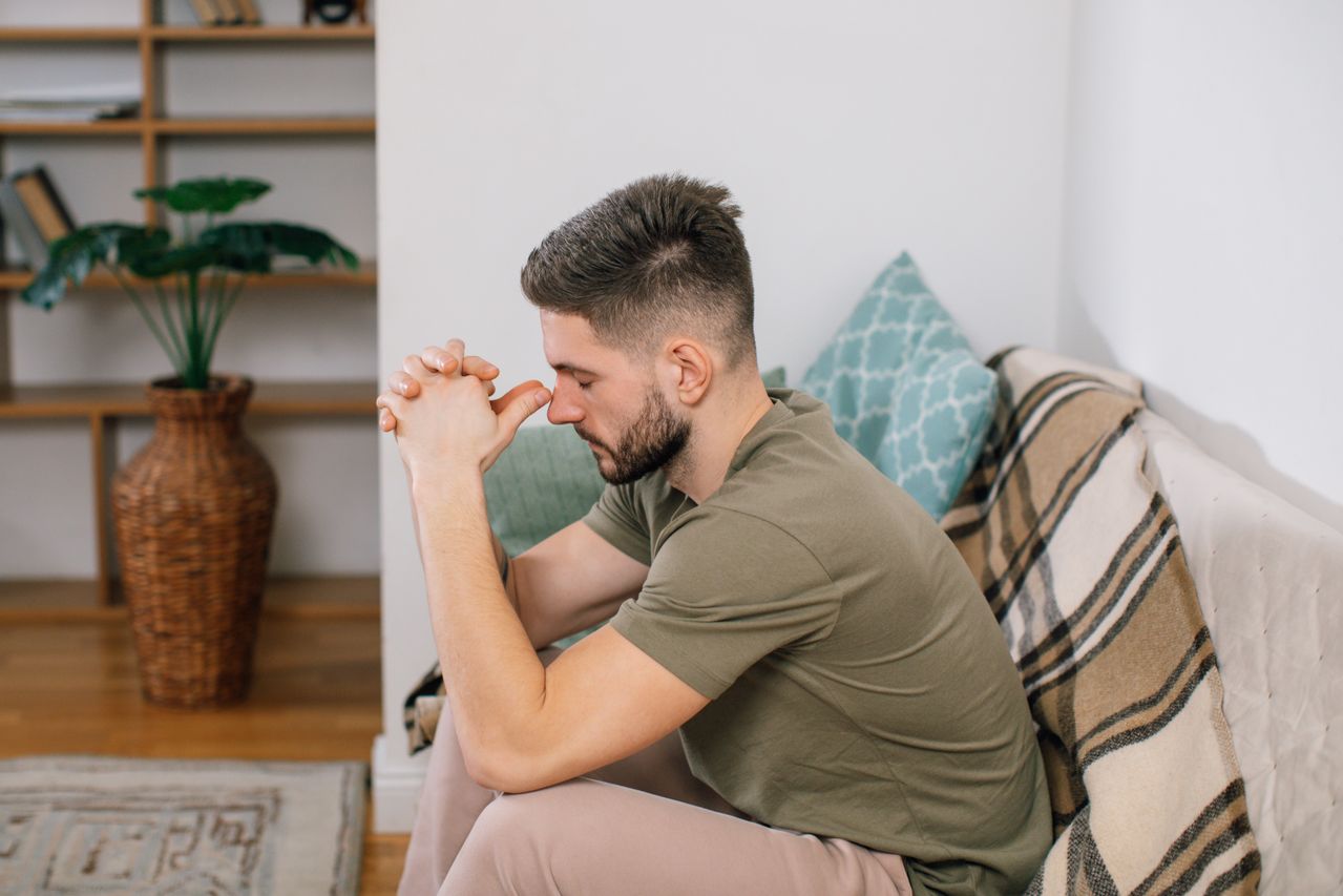 Young man sitting a counselor's couch
