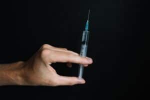hand holding a syringe
