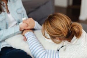 woman being comforted by her therapist