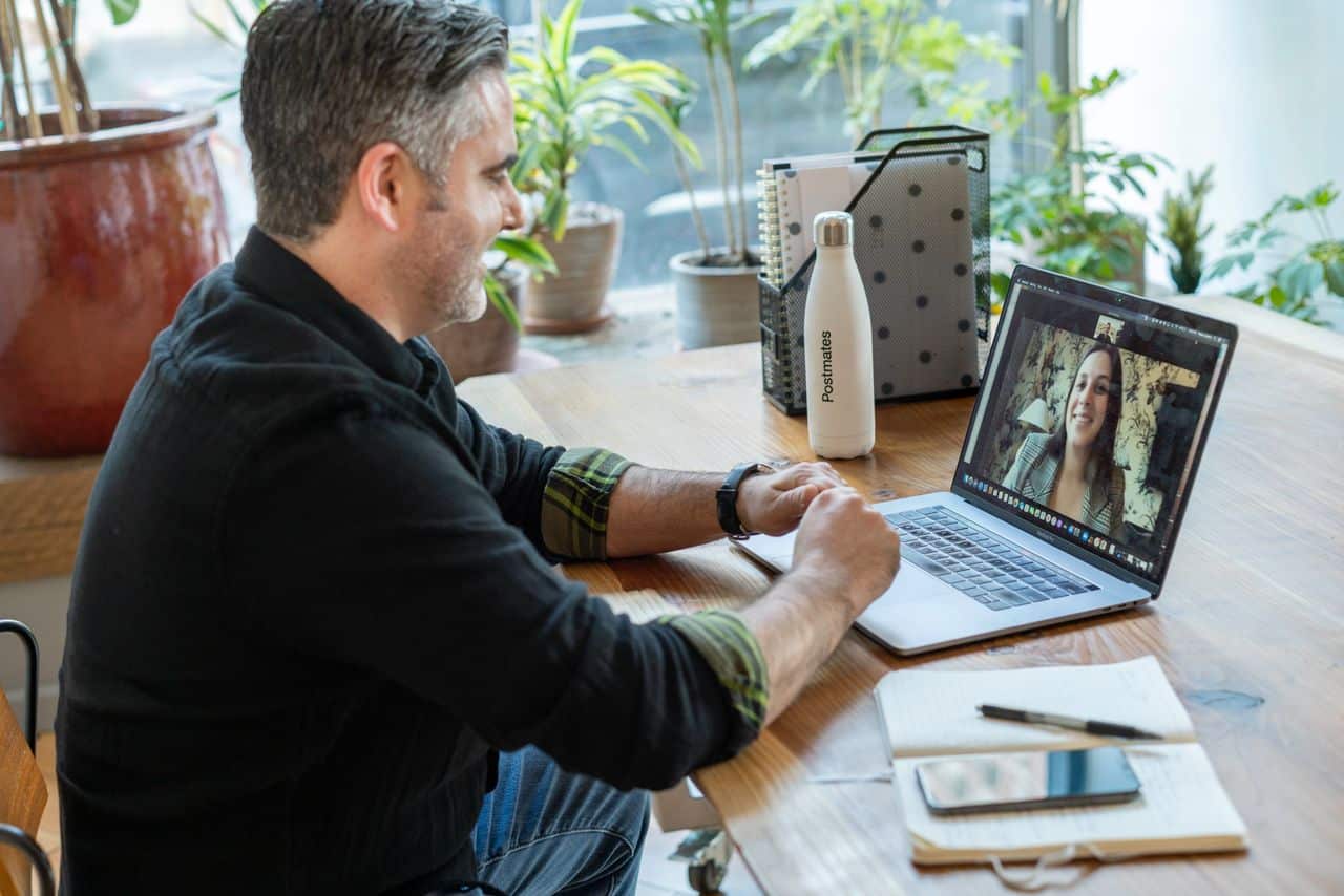 man participates in an online therapy from his home