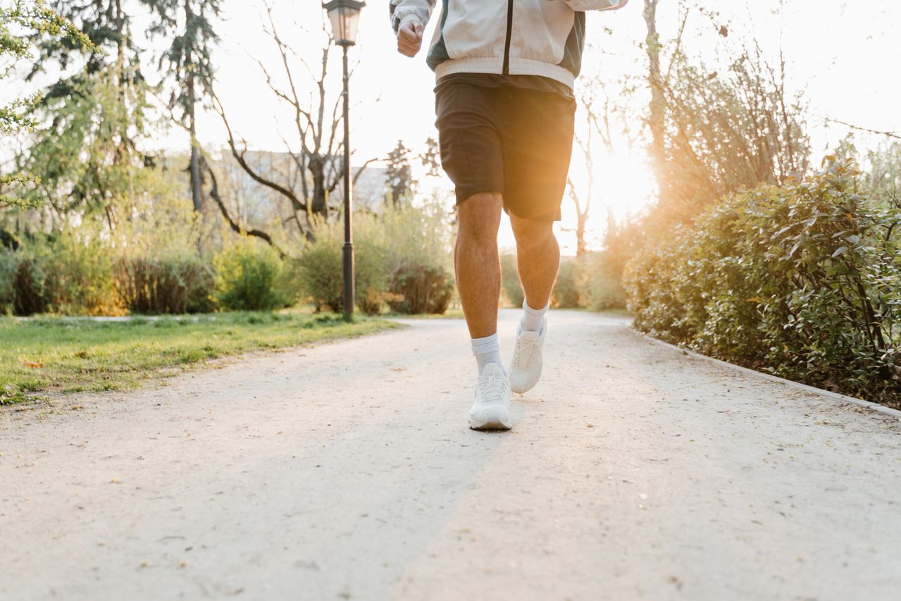 person jogging on a park pathway