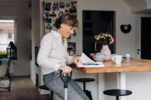 Elderly woman sitting in a cozy kitchen