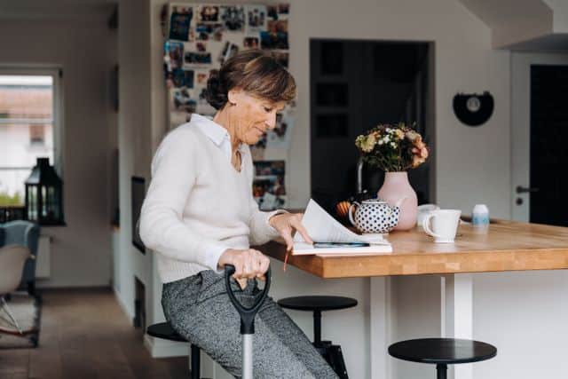 Elderly woman sitting in a cozy kitchen